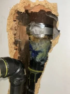 Open sewer pipe being inspected before plumbing work